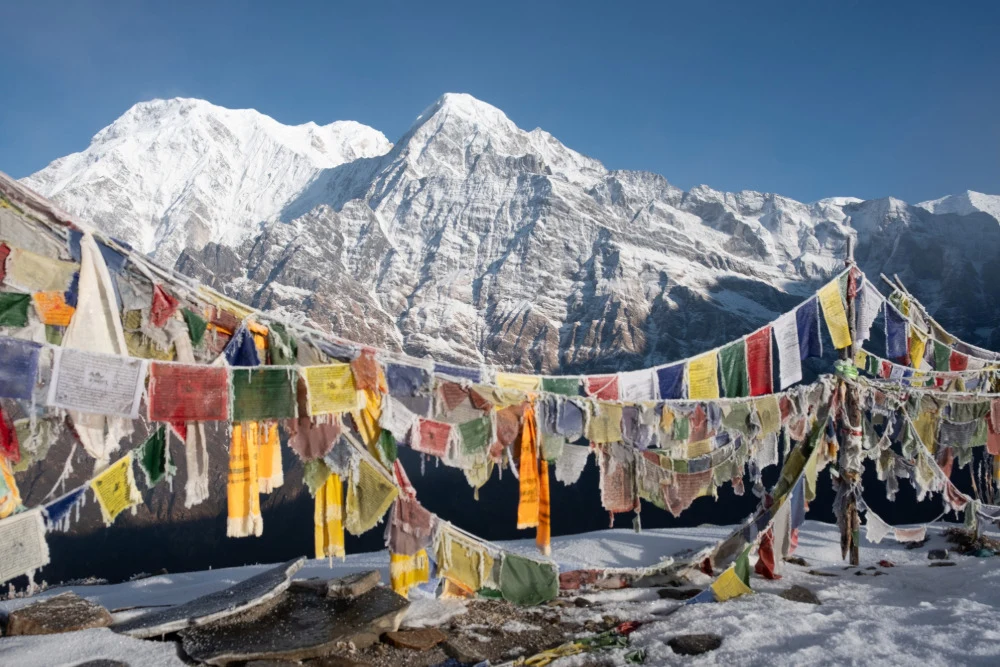 Gefrorene Gebetsfahnen am Mardi Himal Trek in Nepal.